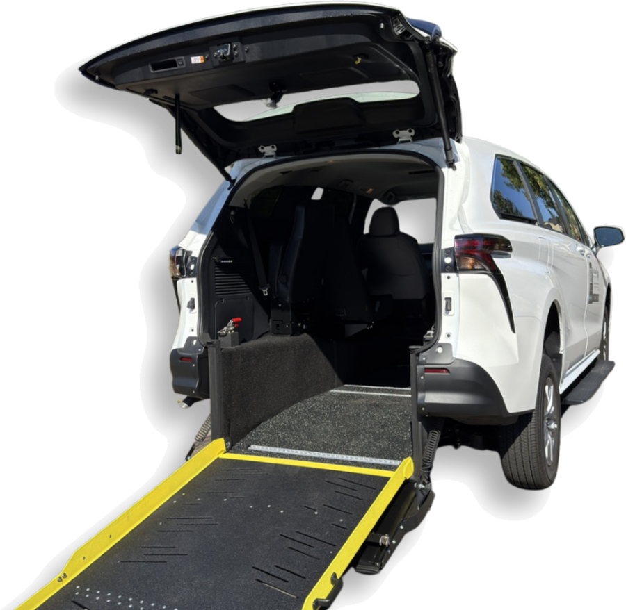 Rear view of an AtlasCare wheelchair-accessible vehicle with the ramp deployed, showing the interior seating and securement area